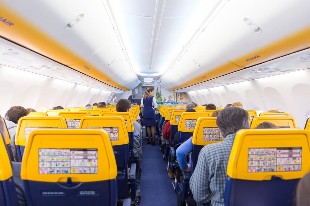 Stewardess Serving Passangers On Ryanair Airplane